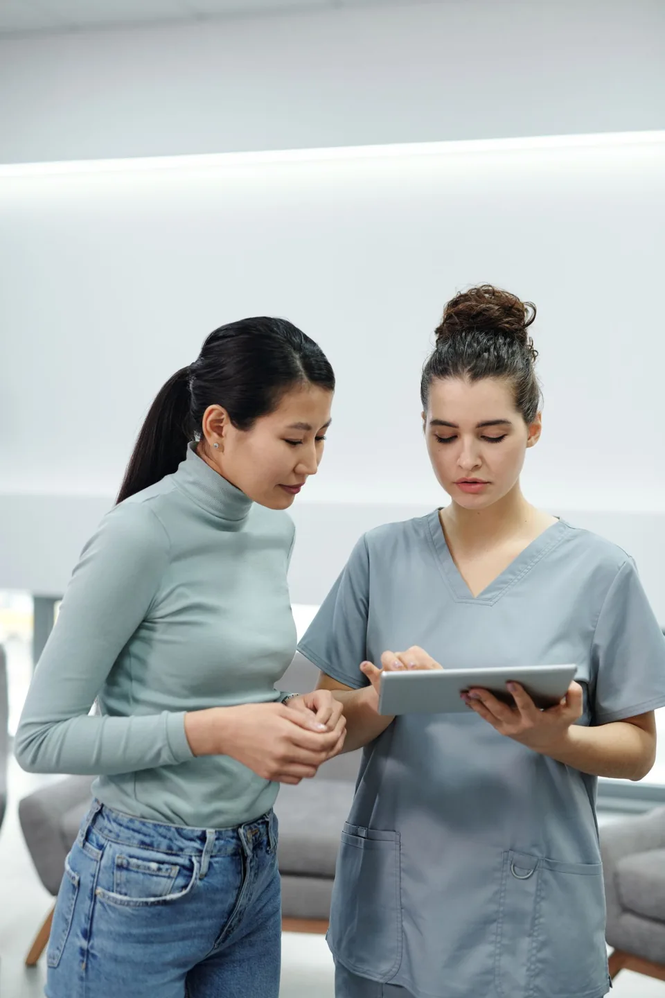 Healthcare professionals reviewing information on a tablet