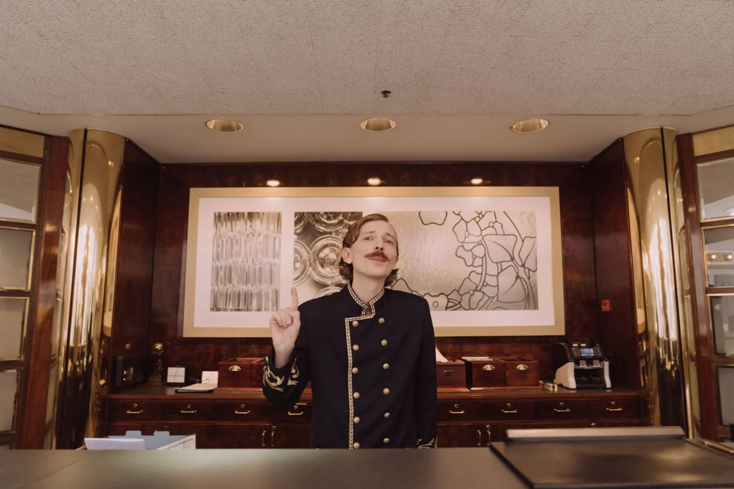 Receptionist welcoming guests at a hotel front desk